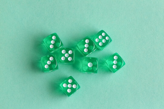 Green game dices on turquoise background