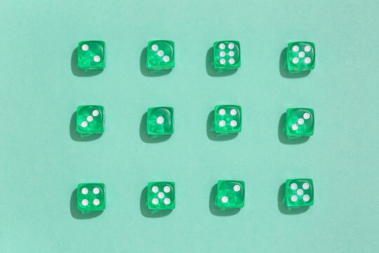 Green game dices on turquoise background