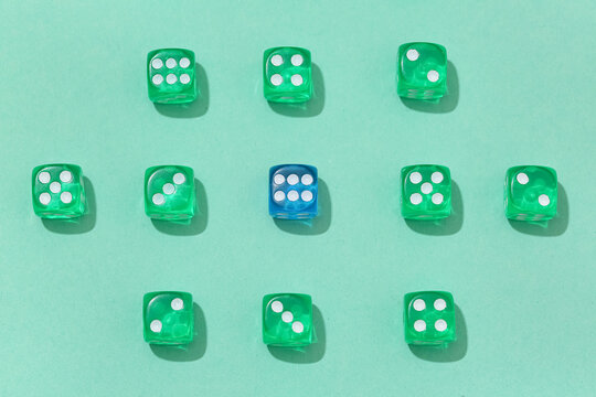 Green and blue game dices on turquoise background