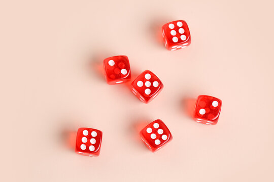 Red game dices on beige background