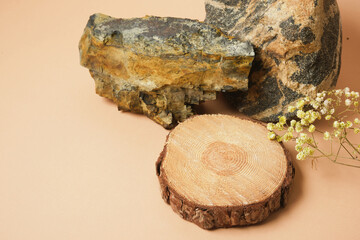 Round Wood cut podium, stone, decorations concept over beige Background for perfume, jewellery and cosmetic products.