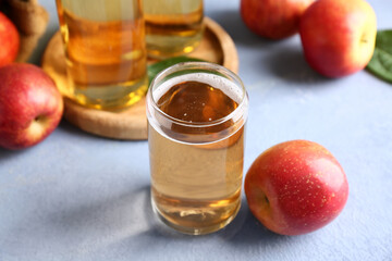 Fresh fruits with glass of apple cider on grey grunge background