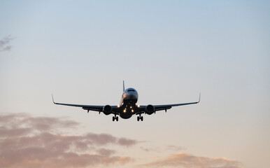 Airplane Flying at Colorful Sunrise Sky