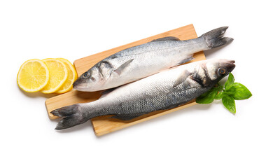 Cutting board with fresh seabass fish, lemon slices and basil leaves isolated on white background, closeup