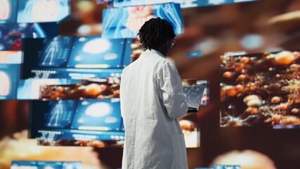 Doctor looking at genomes on notebook screen, comparing infection models. Biomedical specialist wearing lab coat studying pathogens using laptop to design antiviral strategies, camera B - Powered by Adobe