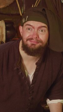 Sly seller hides rare dry roots meeting guest in store. Scared bartender studies magic potion ingredients while adventurer comes in tavern. Fantasy game