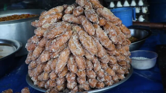 Sweet goja is a food made from flour and sugar. Sweet goja (brown in color) is a crunchy, sweet and salty food made by hand.