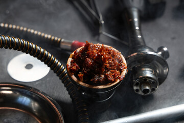 Parts of hookah and tobacco on black background