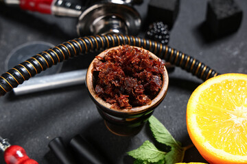 Parts of hookah with tobacco, fruits and mint leaves on black background