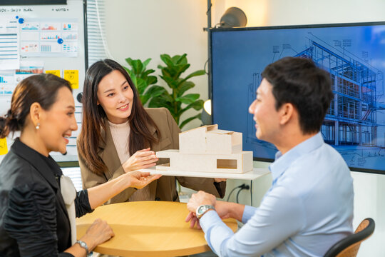 Corporate business team meeting discussion with project manager in office conference room. Group of Architect teamwork working production plan with presentation 3D architectural construction model.
