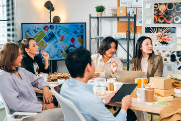 Corporate business team meeting discussion with project manager in office conference room. Man and woman creative teamwork production planning reusable Eco friendly product for sustainable living.