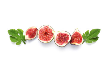 Cut fresh ripe figs and leaves on white background