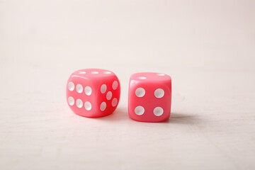 Pink game dices on white background