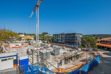 Modern Apartment Building Construction Site with Tower Crane