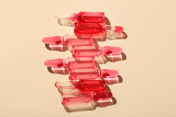 Glass ampoules on light yellow background