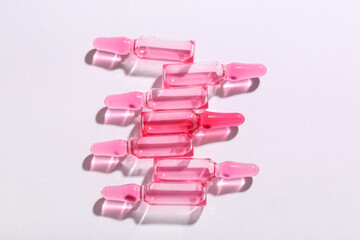 Glass ampoules on light background