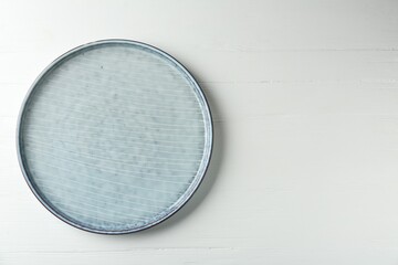 Stylish ceramic plate on white wooden table, top view. Space for text