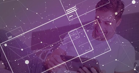 Navigating purple tinted interface, mid adult male using tablet sitting on sofa at home, copy space