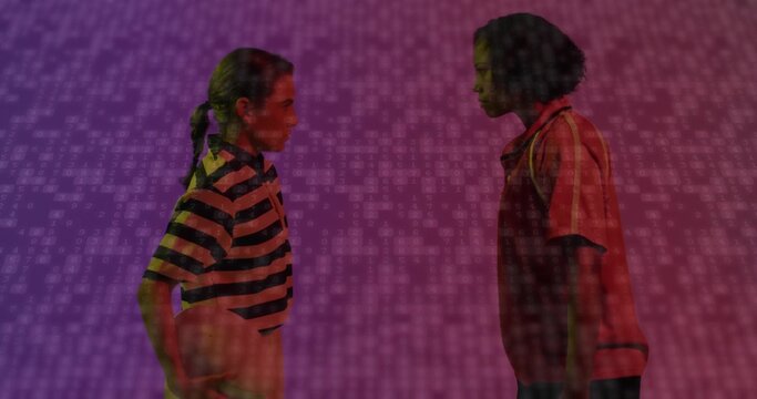 Facing women holding basketball in studio wearing striped red polo shirts with binary-code backdrop - Powered by Adobe