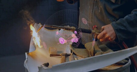 Gloved hands slicing curved metal sheet using oxy-fuel torch in workshop, with holographic network