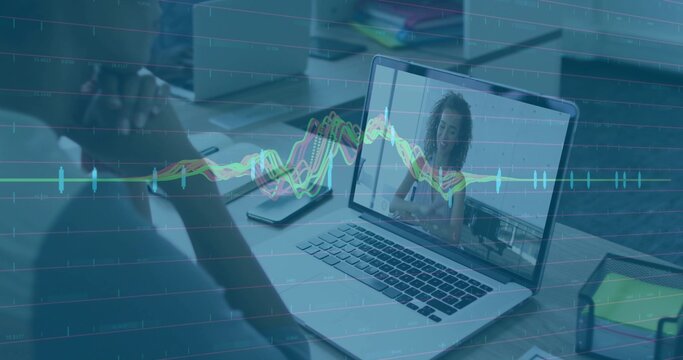 Sitting man facing laptop showing colleague chatting at office workspace with line graph overlay - Powered by Adobe