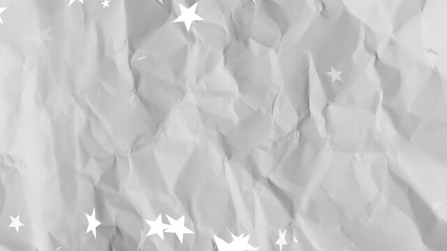 White star shapes emerging top left and drifting clustering splitting fading on crumpled gray paper