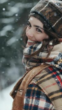 Warm smile of a young lady enjoying the cold weather in a cozy scarf and hat