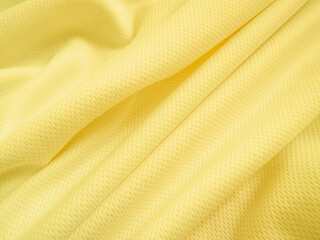Yellow fabric background. Wavy cloth texture
