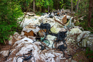 Illegal dump of rubber and polyethylene waste in the forest