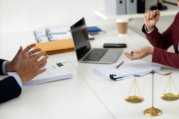Adult legal professionals clients consult discuss important case documents at office desk seeking advice justice resolution strategic negotiation