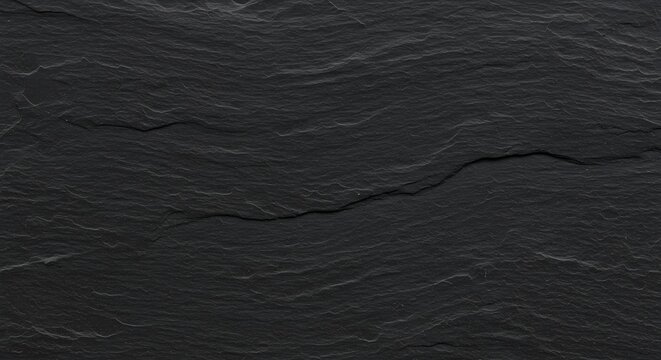 Dark gray textured slate rock with slight ripples and a subtle crack