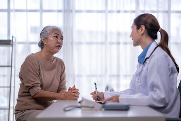 Asian senior woman consulting with female doctor