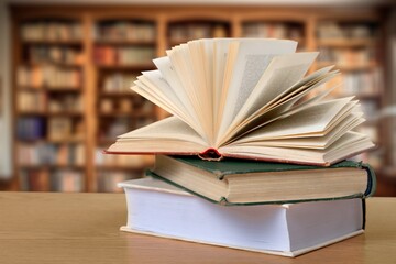 Reading book with open pages on library background