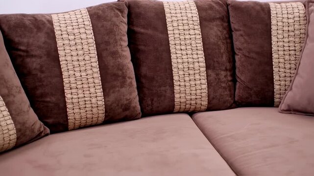 Brown sofa with patterned cushions
