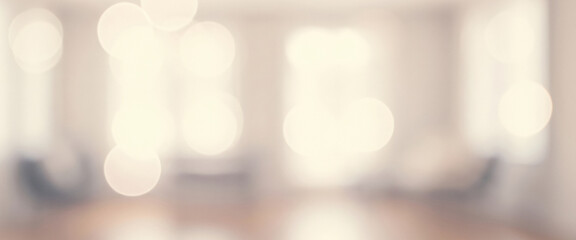 Abstract DSLR blurred interior with sunlight streaming through windows, creating a soft bokeh glow and a calm, professional atmosphere.