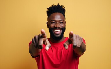 Young african american man with beard wearing casual red t shirt pointing fingers to camera with happy and funny face. good energy and vibes. High quality
