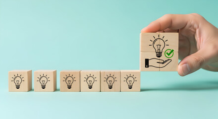Hand placing final idea cube, completing innovation sequence for business growth.