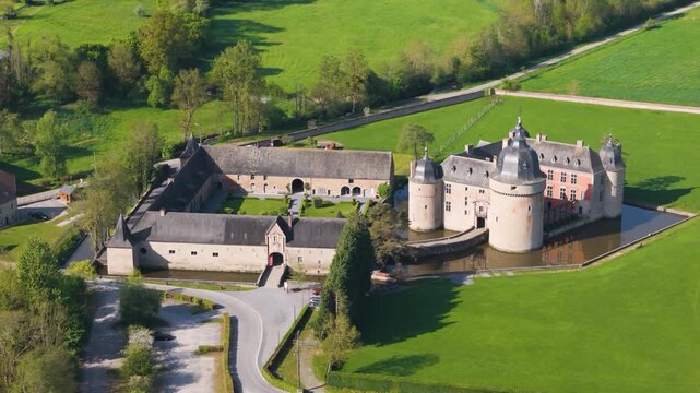 castle lavaux sainte anne or ch&acirc;teau de old building green fields water body gardens trees wallonia belgium to left overhead around right drone panning shot 