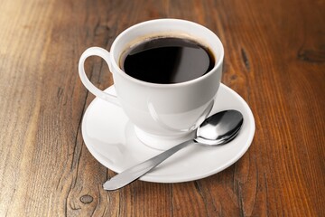 cup of tasty hot americano coffee on desk