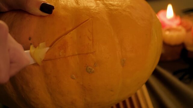 Step in pumpkin carving woman knife shapes expressive eye for the traditional jack o lantern