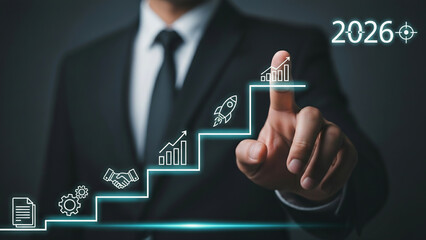 Businessman touching digital steps showing business growth strategy and success target for 2026 concept