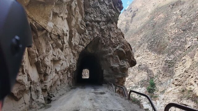 Huaraz, Peru: Point of view footage of motorcycle rider driving through tunnel in Canon del Pato close in Huaraz region, Peru. Famous narrow road in between cordillera blanca and cordillera negra