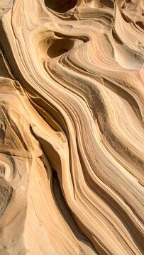 Close-up view of layered sandstone formations with swirling patterns