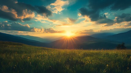 A picturesque sunset over a rolling green field and mountains, casting a warm glow on the landscape.