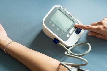 Man check blood pressure monitor and heart rate monitor with digital pressure gauge. Health care and Medical concept	