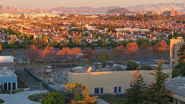 Golden light stretches over the College of Alameda as the sun rises, captured from a calm morning aerial perspective.