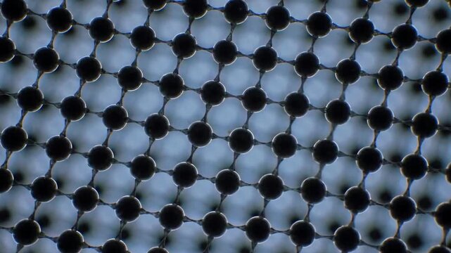 Macro view of an interconnected, molecular structure, black spheres linked with greyish supports