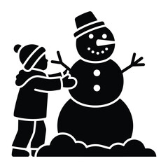 Child happily building a snowman in winter snow enjoying a festive season activity