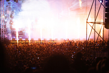 Crowd at concert and blurred stage lights.