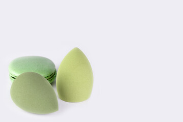 Soft pastel composition with makeup tools and dessert accent, minimal style.